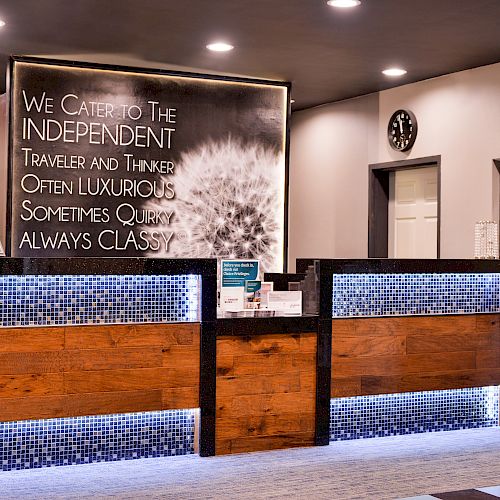 The image shows a hotel reception area with a sign that reads: 