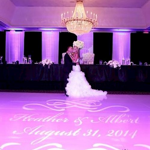 A bride stands in a ballroom under a chandelier, with the names 